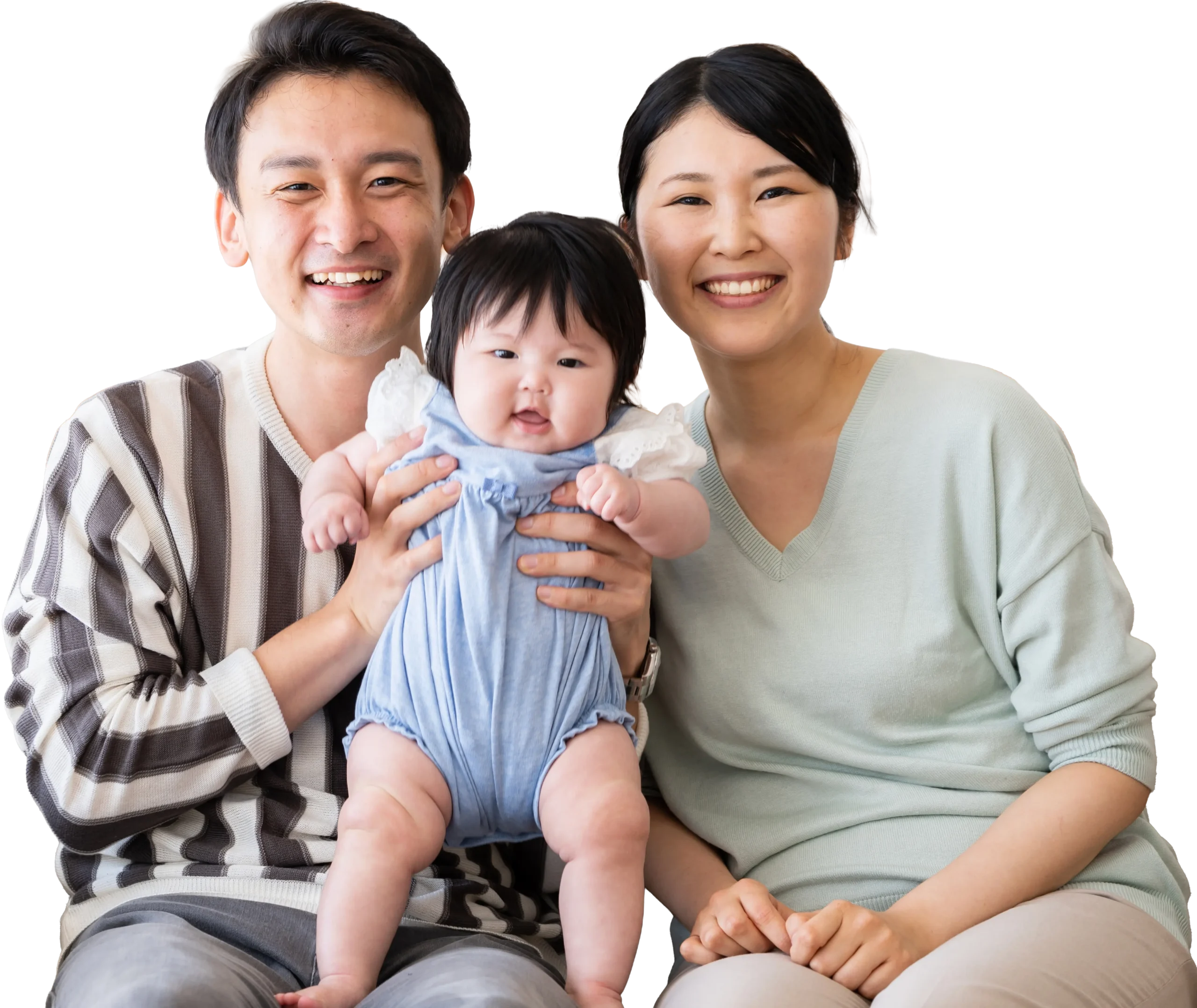 Asian parents holding smiling baby at home